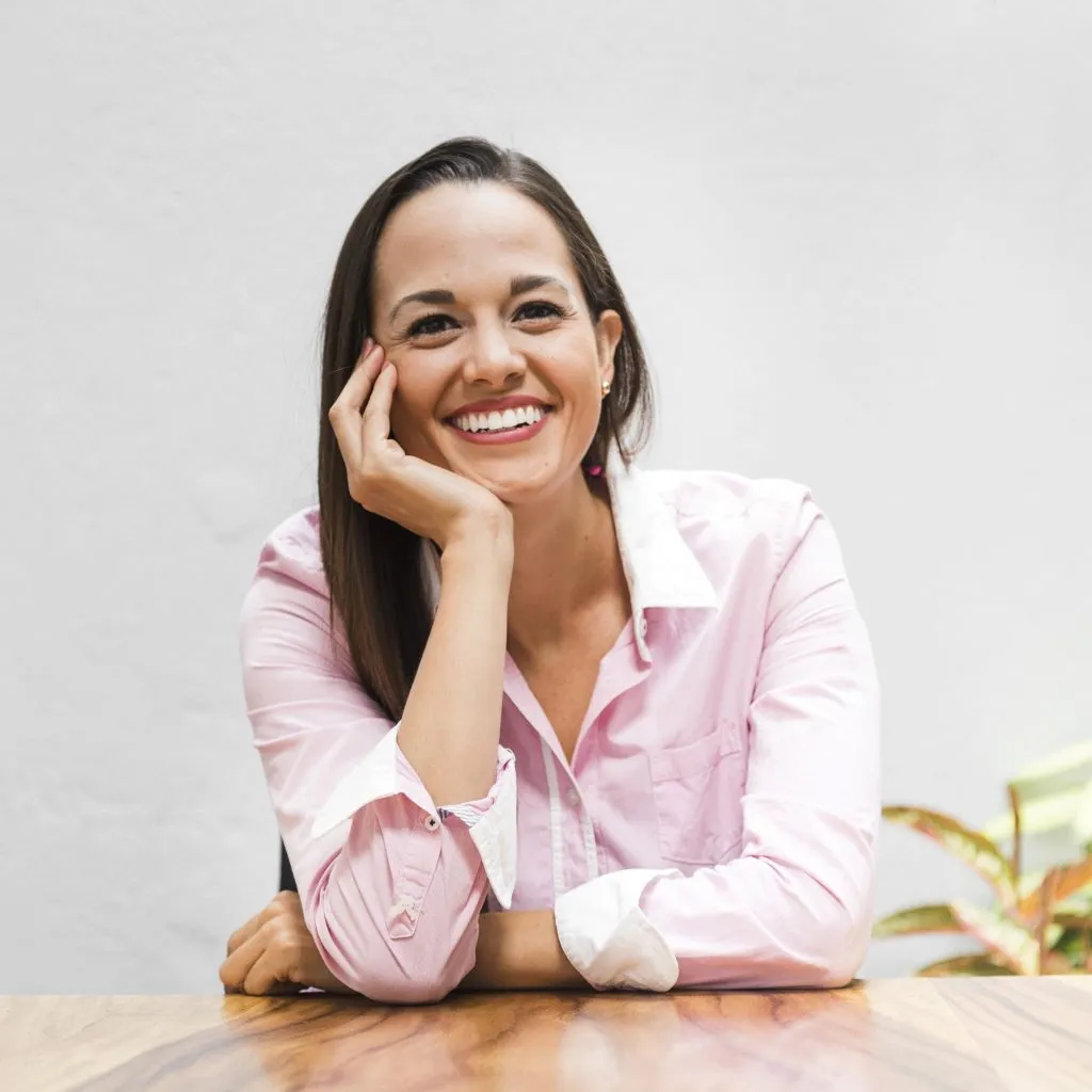 Smiling Woman Sitting At Table
